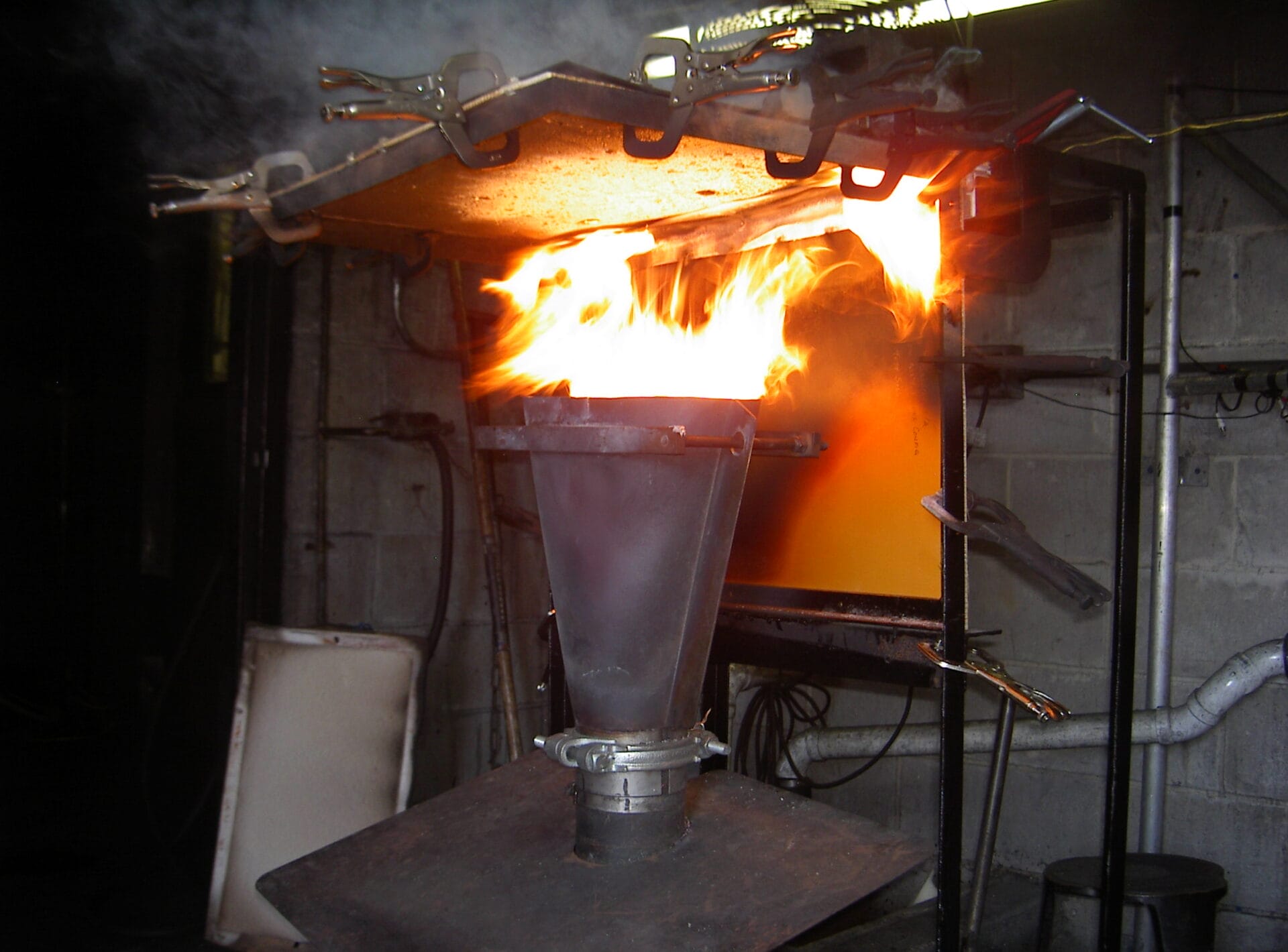Aircraft component being blasted with fire in flammability testing lab